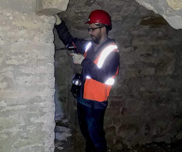 Ecologist Mark Norris inspecting a crevice in the wall of the Grand Bridge.
